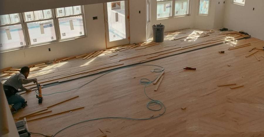 W&K crew member installing hardwood flooring during a Connecticut rebuild